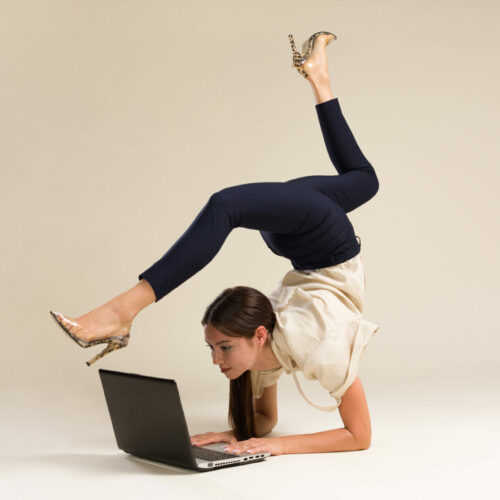 Young Gymnast Business Woman Stretching And Working On Computer
